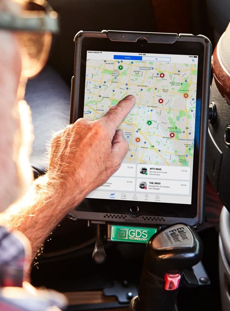 Driver using a tablet to monitor a live dispatch map